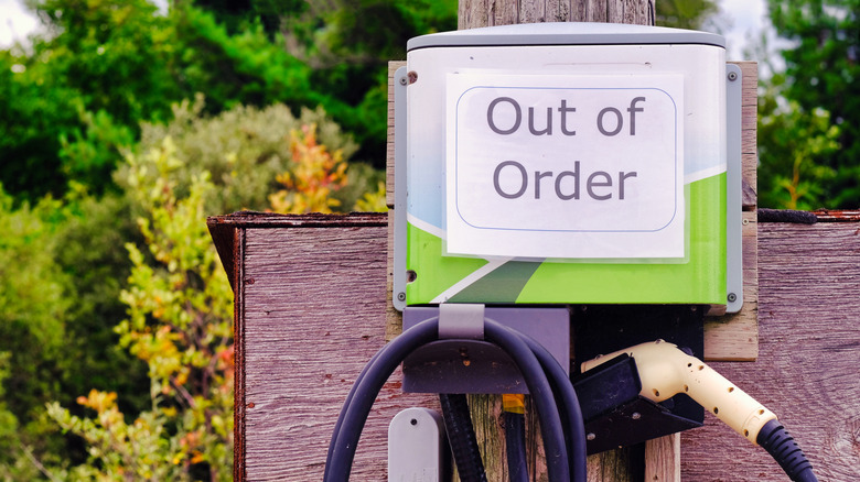 An EV charging station with an Out of Order sign attached to it