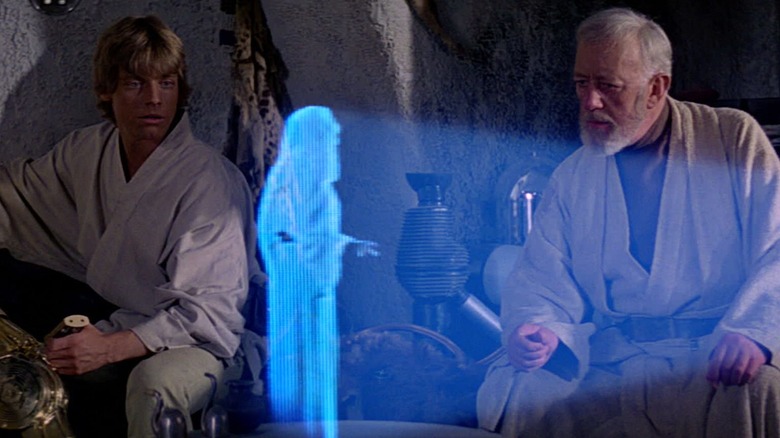C-3PO, Obi-wan, and Luke in hut with hologram