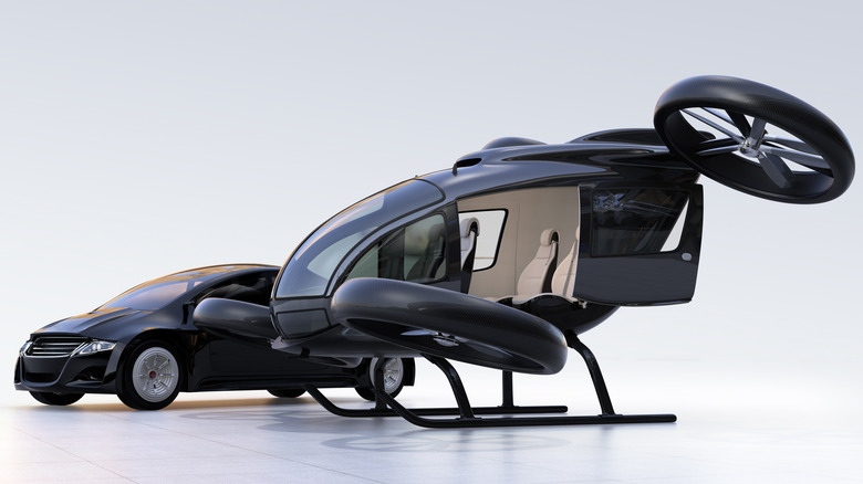 Carro autônomo preto e drone de passageiros