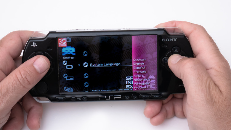 Person playing PlayStation Portable (PSP)