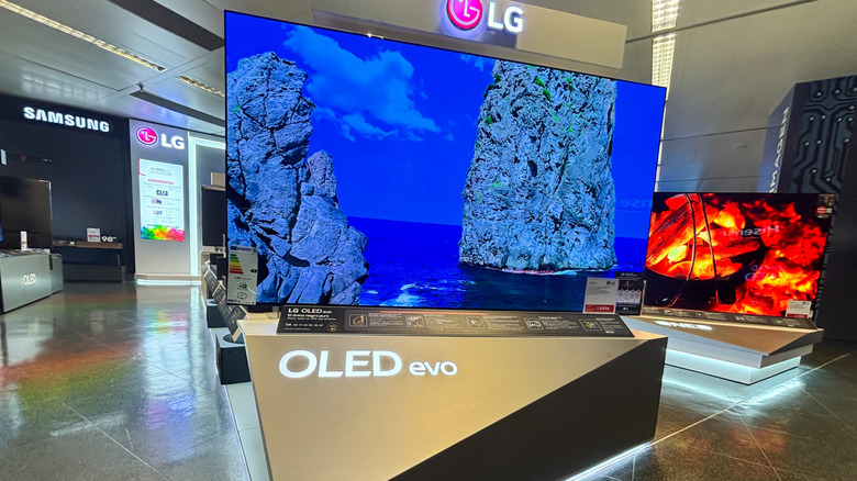LG OLED evo TV is prominently featured in a contemporary electronics showroom