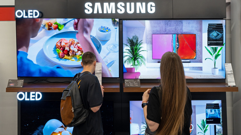 two people looking at Samsung OLED TV store display