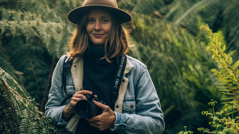 Woman holding OM-1 camera