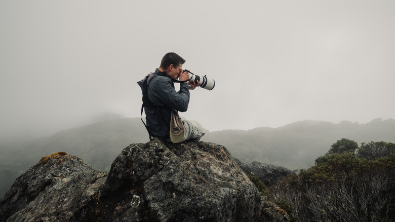 Man holding OM-1 camera