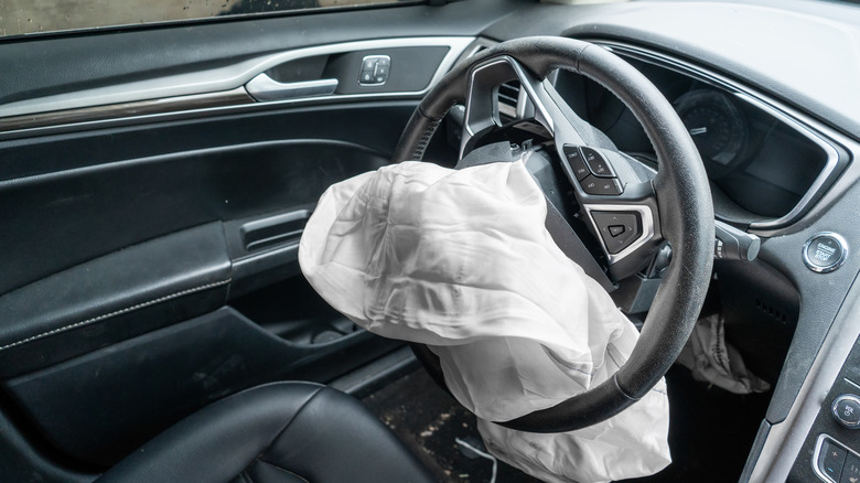Car steering wheel with a deployed airbag