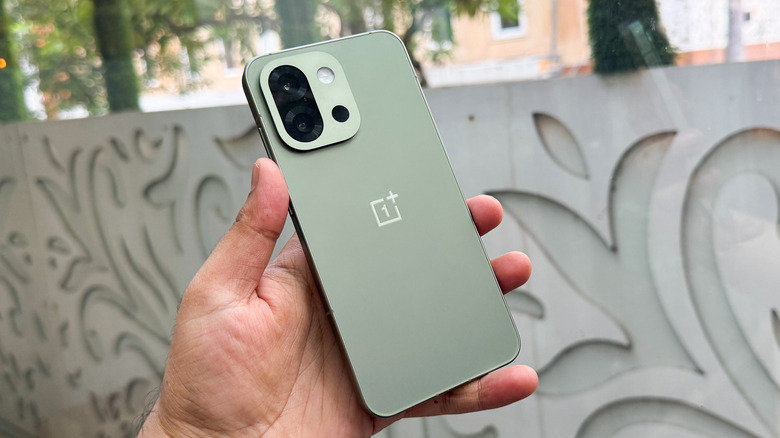 Person holding a OnePlus 13s.