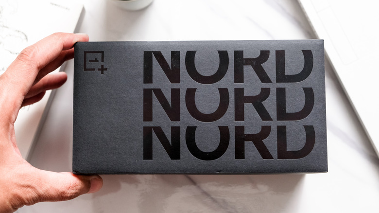 Man holding OnePlus Nord box.