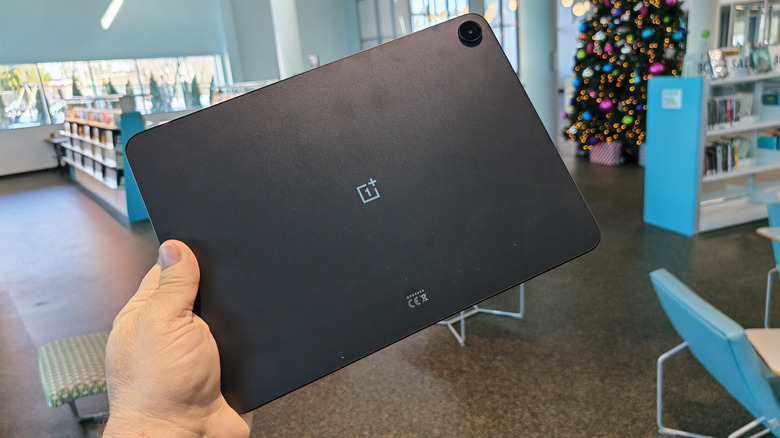 man holding the OnePlus Pad 2 Go