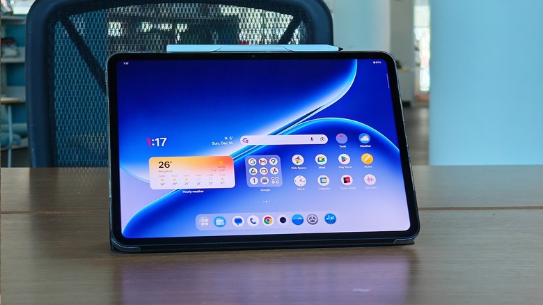 Man holding the OnePlus Pad 2 Go