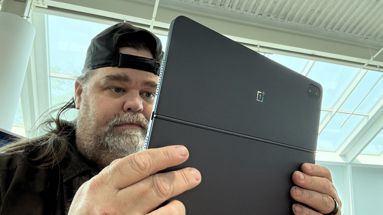 Man reading on a OnePlus Pad 3
