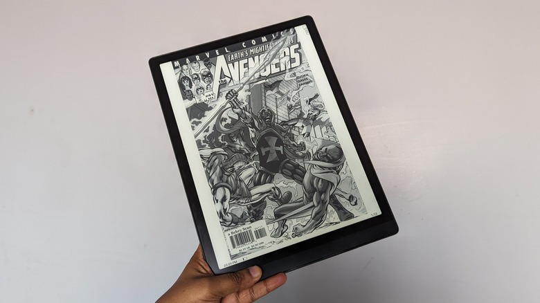 Onyx Boox Tab X in hand with an Avengers comic on the screen