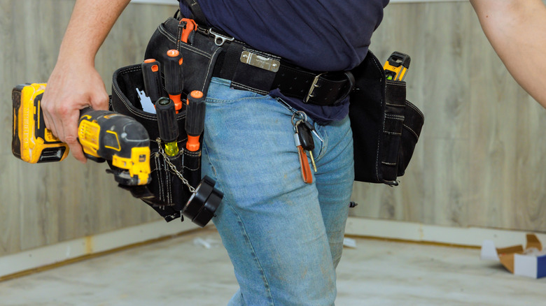 tradesman holding an oscillating multitool