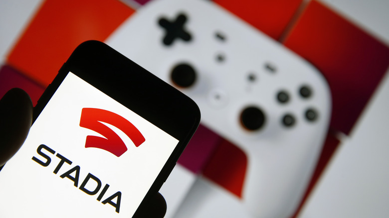 Stadia on a phone with a Stadia controller behind