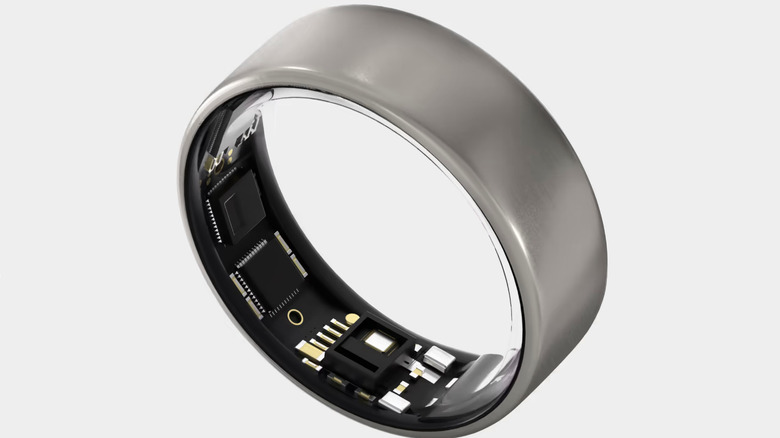 The Ultrahuman Ring Air in its Raw Titanium color option and with its data-collecting sensors showing