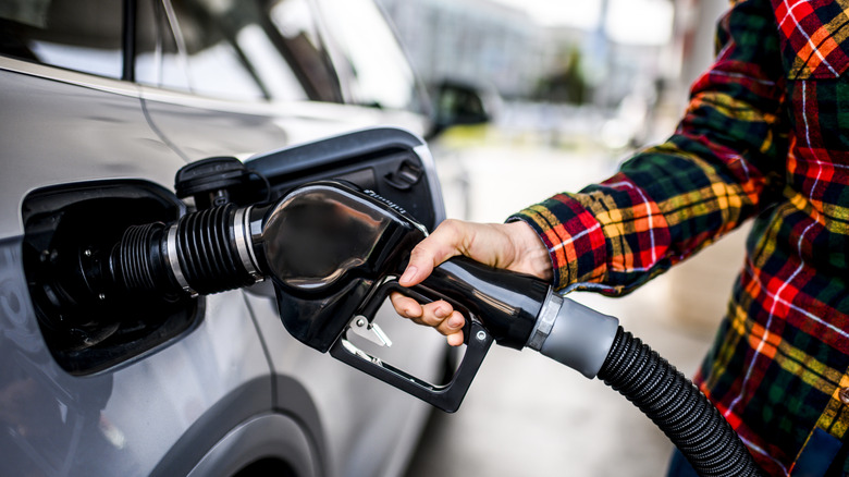 A person filling up their car at a gas station