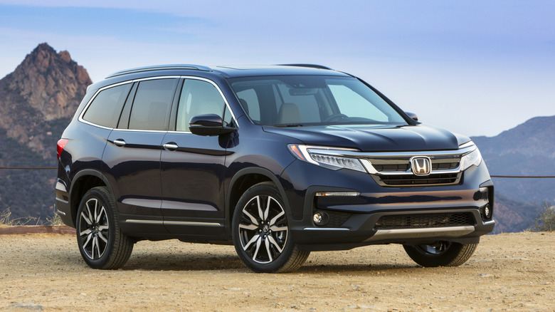 Black 2021 Honda Pilot parked in the mountains
