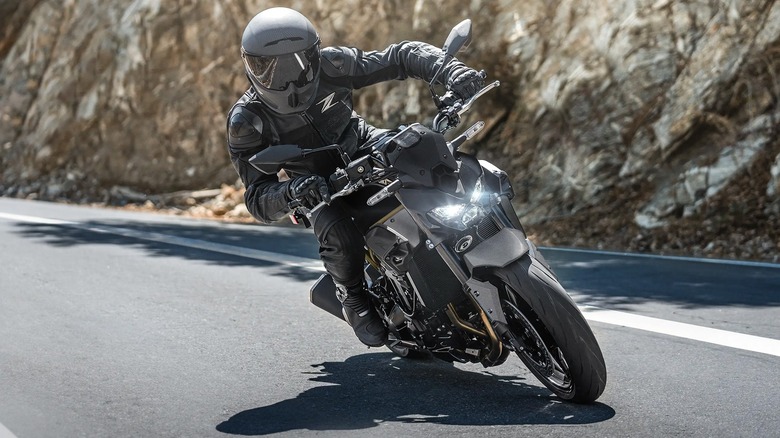 Kawasaki z900 with a rider in black protective gear