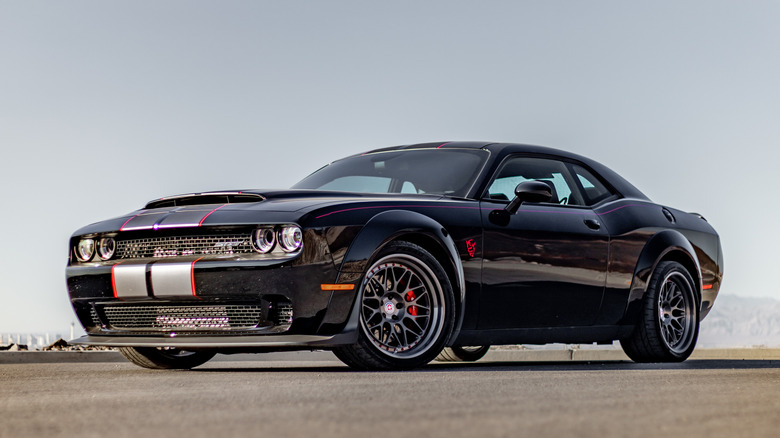 Black dodge demon parked under a grey sky.