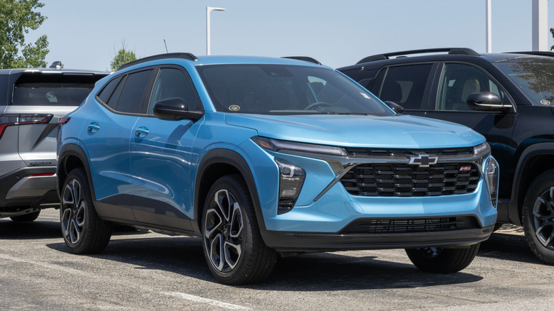A blue Chevrolet Trax among other vehicles.