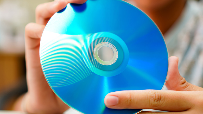 Person holding a blu-ray disc