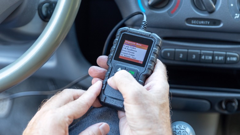person checking car with OBD scanner