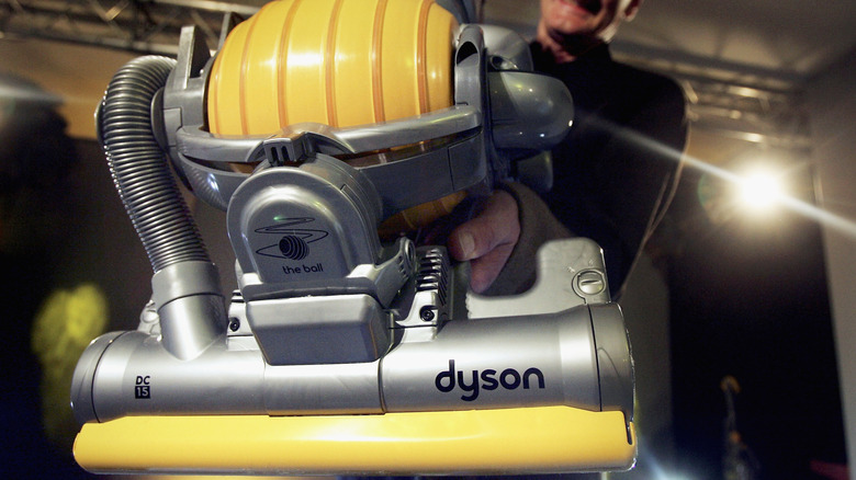 James Dyson with vacuum cleaner