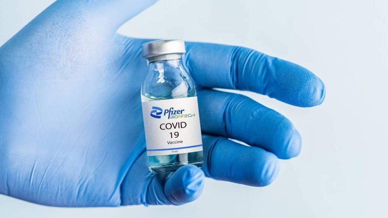 Pfizer vaccine vial in hand