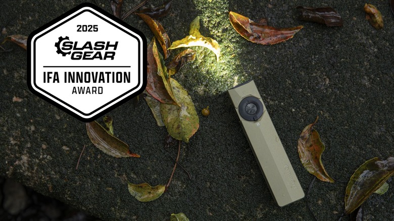 Olight ArkPro in nature, with SlashGear Innovation Badge superimposed over the photo
