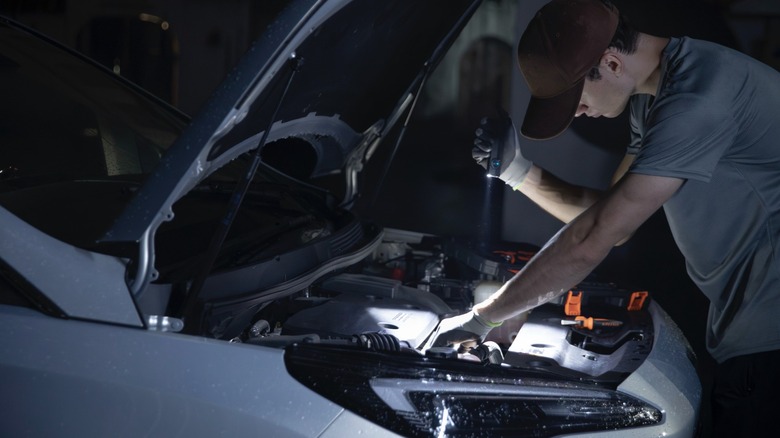 Person using ArkPro to check under vehicle hood