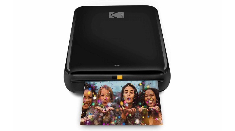 A black KODAK Step printing a photo of four women