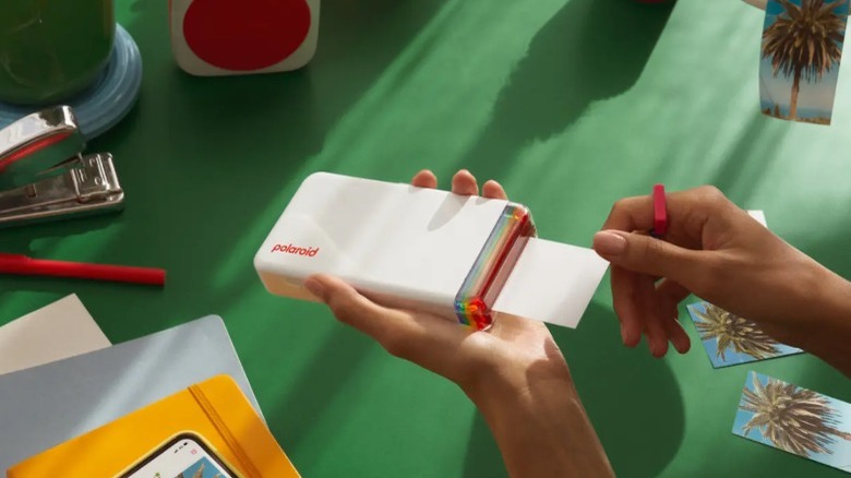 Person using the Polaroid Hi-Print to print a photo