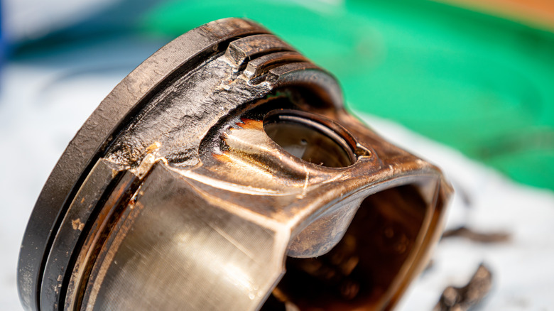 Close-up of piston showing catastrophic damage to ring areas