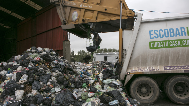 truck unloading heaps of waste