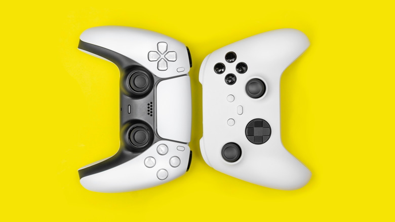 PS5 and Xbox controllers on yellow background