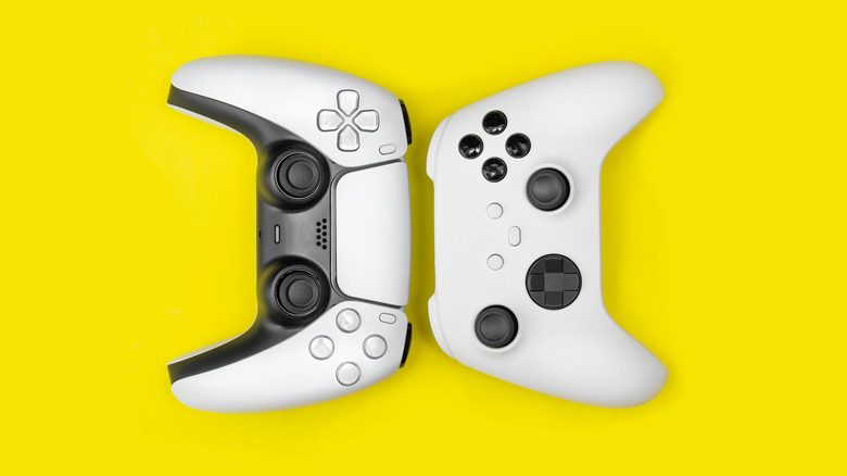 PS5 and Xbox controllers on yellow background