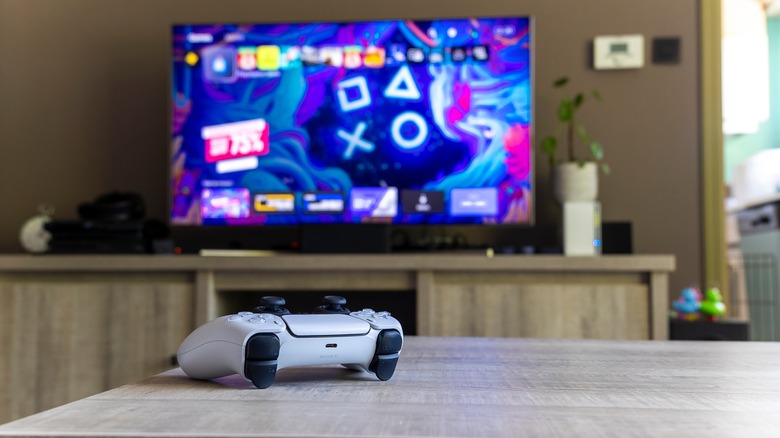 DualSense controller with PS5 on TV
