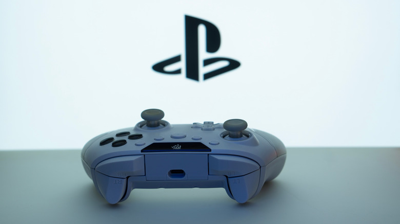 Sony PlayStation controller with brand logo in the background