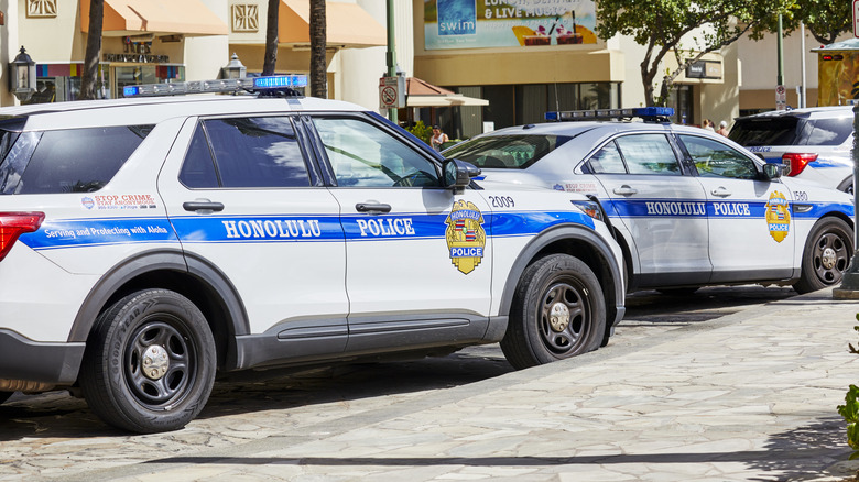 Several Honolulu Police Vehicles Parked Along The Street