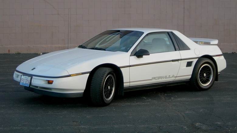 Close-up of a red Pontiac Fiero's headlight cover