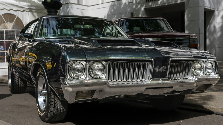 Green 1970 Oldsmobile 442 parked on pavement
