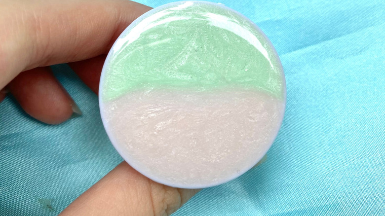 A crystal-finished PopSocket in front of a blue background.