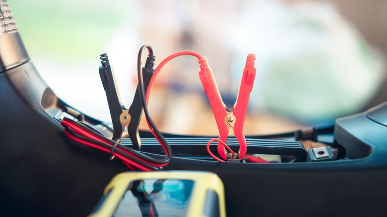 A close up shot a battery charger trickle charging a motorcycle.