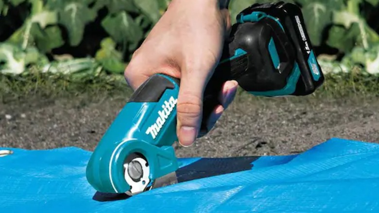 cutting tarp material with Makita multi-cutter