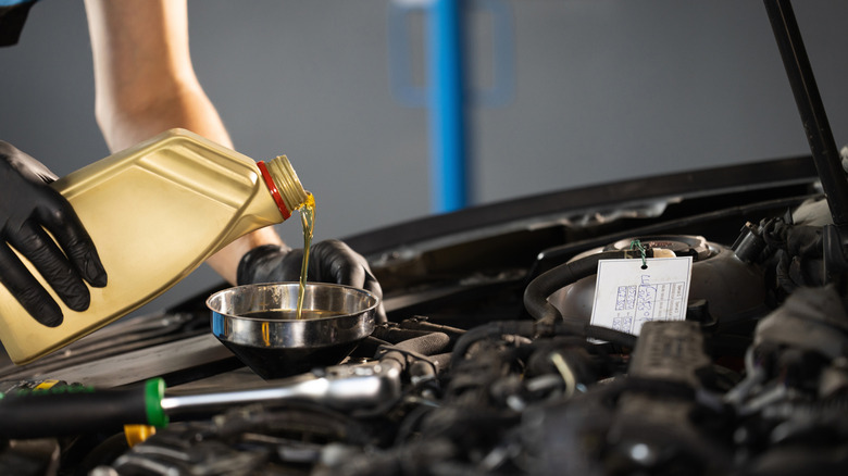 pouring oil into an engine