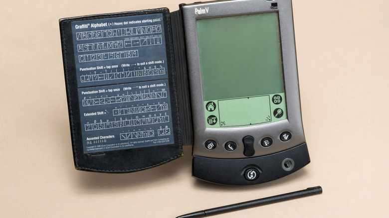 Palm V PDA with stylus.