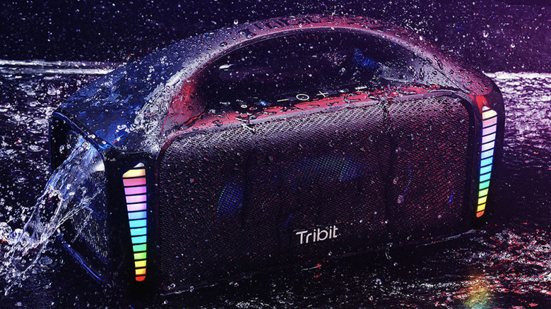 Tribit Stormbox Blast playing with water drops falling around it