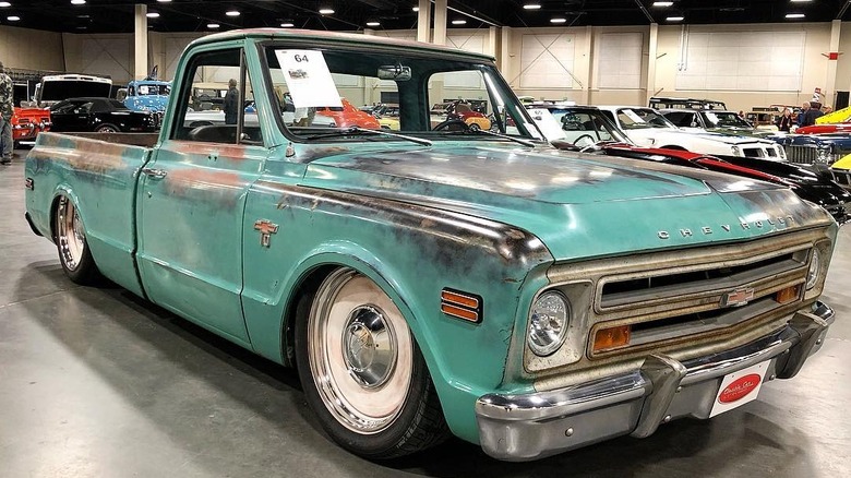 Custom 1968 Chevrolet C10 with suspension in lowered configuration, parked at car show, front-right 3/4 view