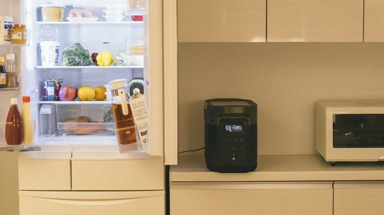 Refrigerator plugged into EcoFlow power station on kitchen counter