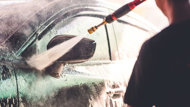 cleaning car with pressure washer
