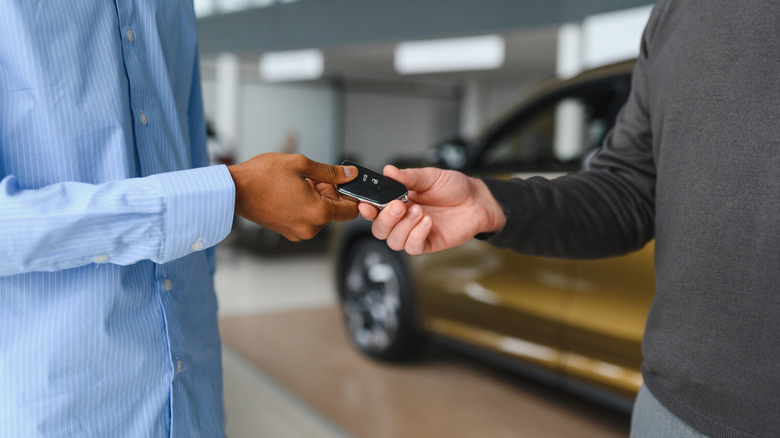 Car owner handing their keys over to a customer service rep